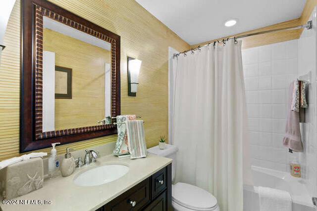 full bathroom with vanity, toilet, and shower / bath combo with shower curtain