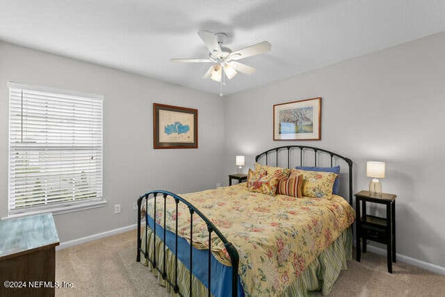 bedroom featuring ceiling fan and light colored carpet