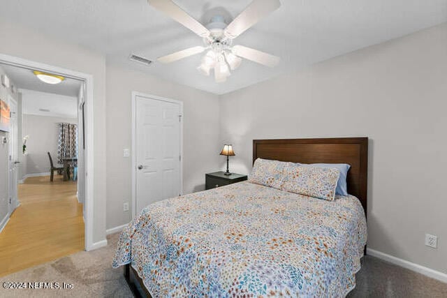 bedroom with ceiling fan and wood-type flooring