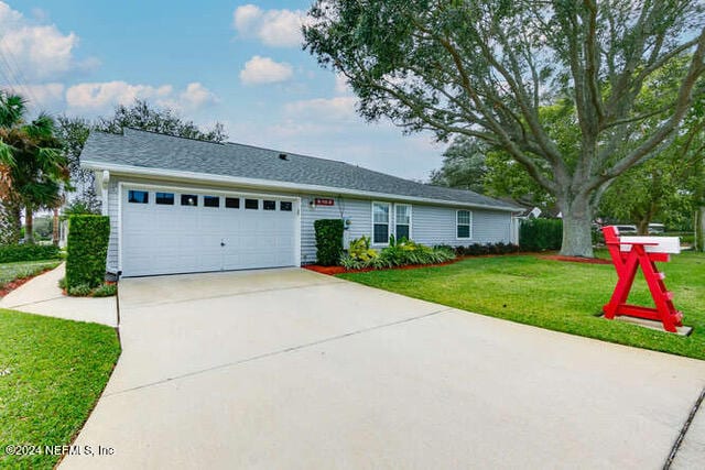 ranch-style home featuring a garage and a front yard