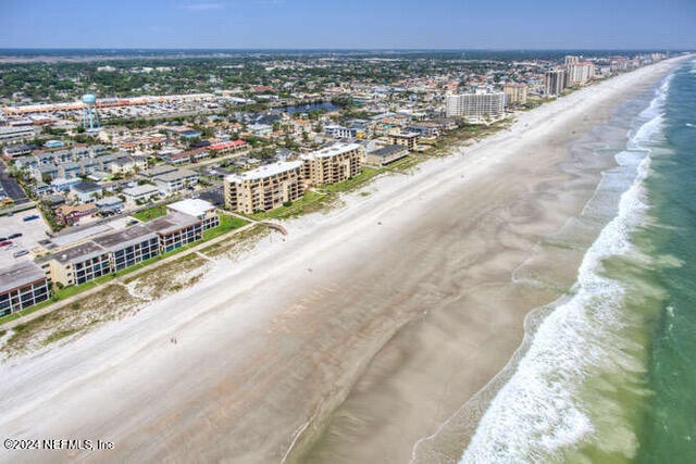 drone / aerial view with a view of the beach and a water view