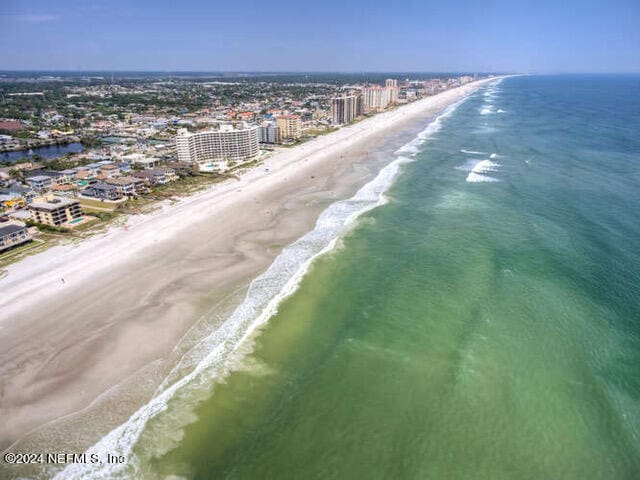 drone / aerial view featuring a view of the beach and a water view