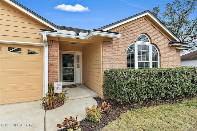 doorway to property featuring a garage