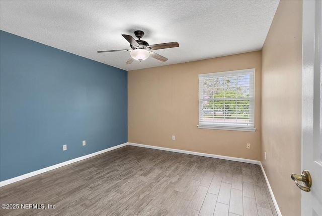 empty room featuring a textured ceiling, hardwood / wood-style floors, and ceiling fan