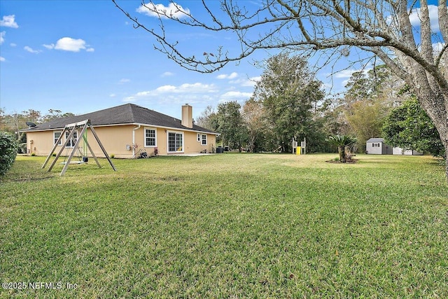 view of yard with a playground and a shed