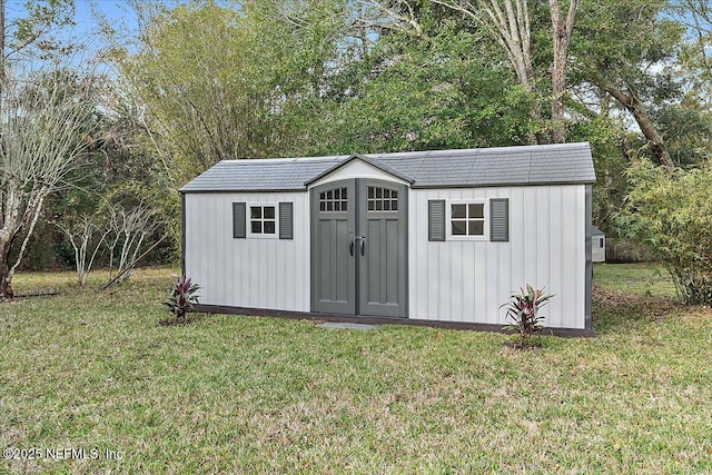 view of outdoor structure with a yard