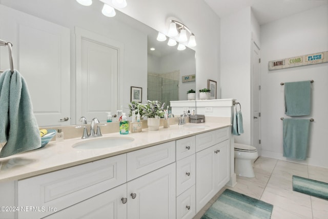 full bath with a sink, marble finish floor, a shower stall, and double vanity