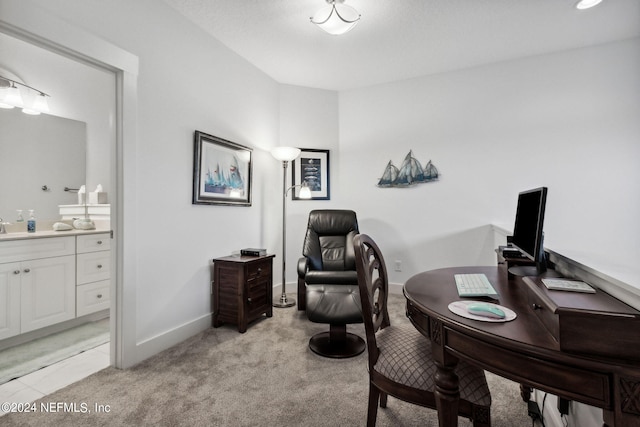 office space featuring light colored carpet and baseboards