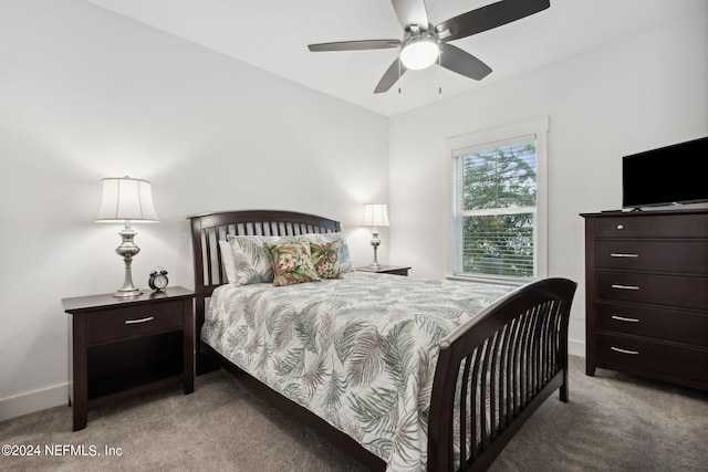 carpeted bedroom featuring baseboards and ceiling fan