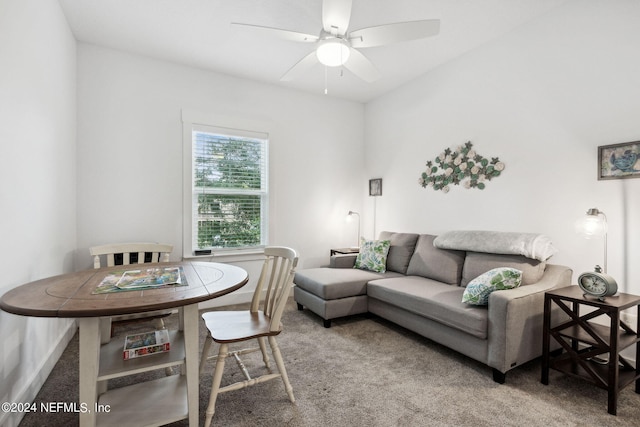 living area with carpet and ceiling fan