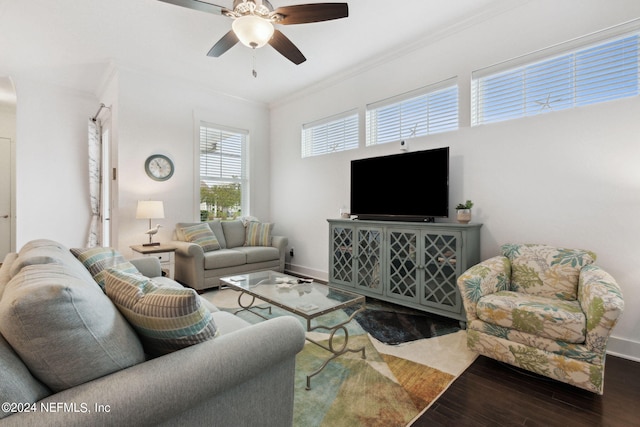 living room with a ceiling fan, wood finished floors, baseboards, and ornamental molding