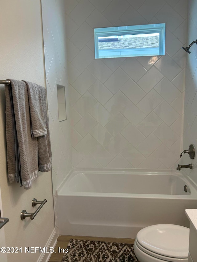 full bathroom with vanity, toilet, and tiled shower / bath