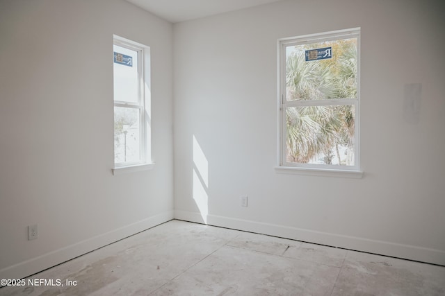 spare room with baseboards