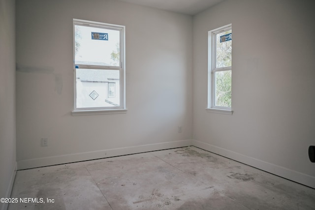 spare room with baseboards