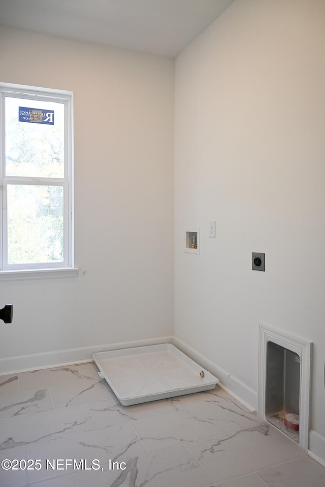 laundry area with marble finish floor, hookup for a washing machine, electric dryer hookup, laundry area, and baseboards