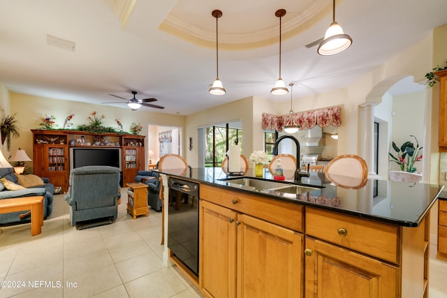 kitchen featuring sink, black dishwasher, an island with sink, a raised ceiling, and ceiling fan