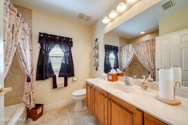 full bathroom featuring tile patterned flooring, vanity, toilet, and shower / bath combo with shower curtain