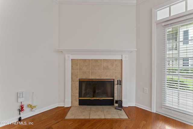 details with hardwood / wood-style flooring, a fireplace, and ornamental molding