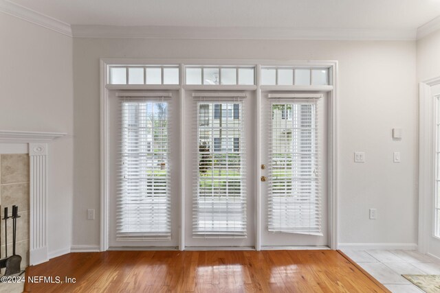 entryway with light hardwood / wood-style flooring and ornamental molding