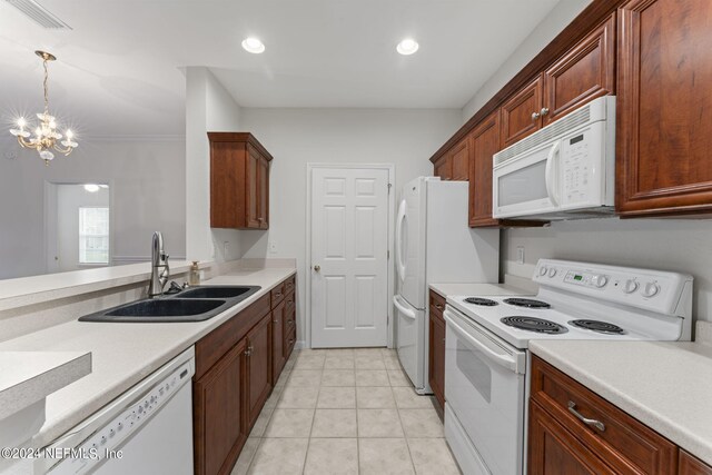 kitchen featuring decorative light fixtures, white appliances, a notable chandelier, sink, and light tile patterned flooring