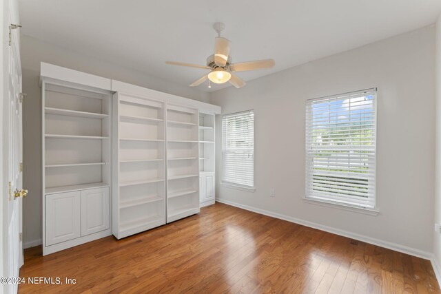 unfurnished bedroom featuring hardwood / wood-style floors and ceiling fan