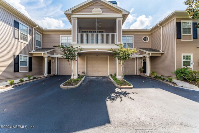 townhome / multi-family property featuring a balcony and a garage