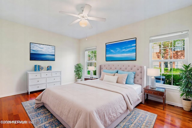 bedroom featuring ceiling fan, baseboards, and wood finished floors