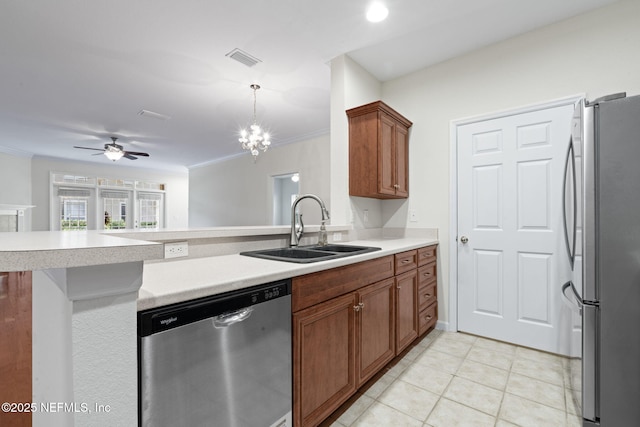 kitchen with brown cabinets, a sink, visible vents, and stainless steel appliances
