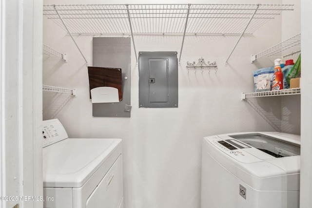laundry area featuring electric panel, washer and clothes dryer, and laundry area