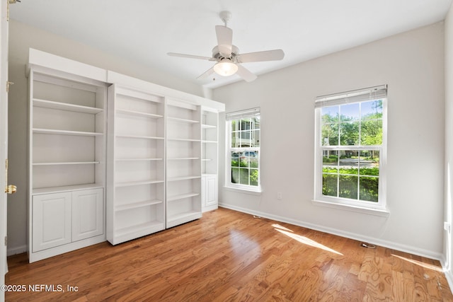 unfurnished bedroom with baseboards, ceiling fan, and wood finished floors