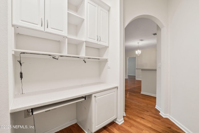mudroom with visible vents, baseboards, arched walkways, ornamental molding, and light wood-type flooring