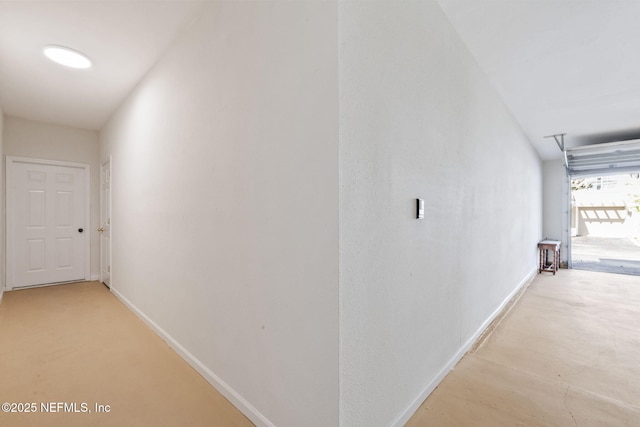 hall with attic access and baseboards