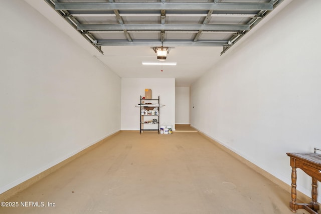 garage with baseboards and a garage door opener