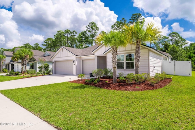 view of front of home with a front lawn and a garage