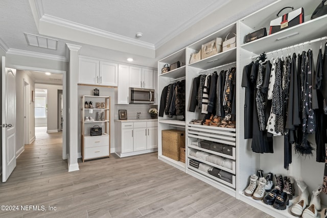 walk in closet featuring light hardwood / wood-style floors