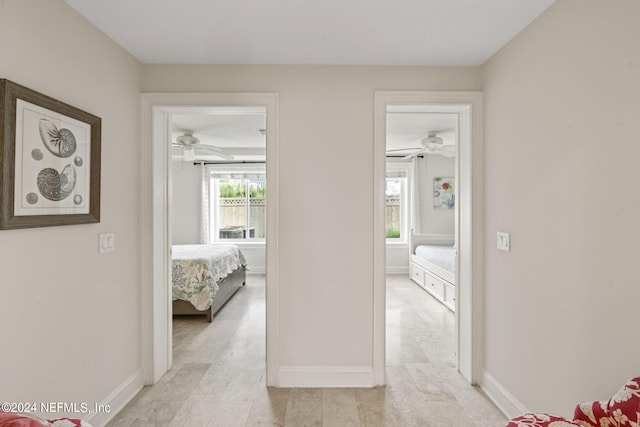 hall featuring baseboards