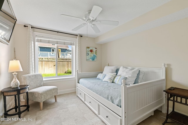 bedroom featuring baseboards and a ceiling fan