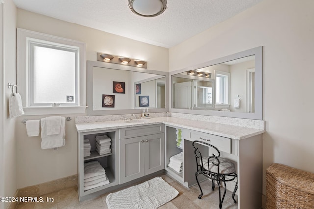 bathroom with vanity and a textured ceiling