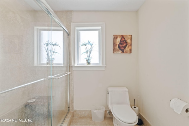 bathroom with toilet, walk in shower, and tile patterned flooring