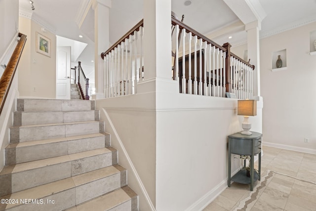 stairway featuring ornamental molding and decorative columns