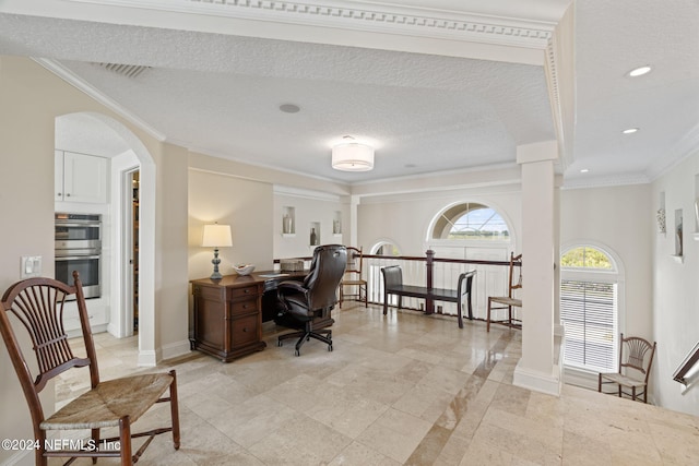 home office featuring crown molding, arched walkways, ornate columns, and a textured ceiling