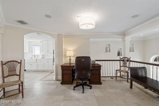 home office featuring ornamental molding, a textured ceiling, and sink