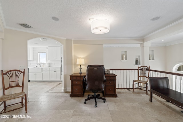 home office with visible vents, arched walkways, a textured ceiling, and crown molding