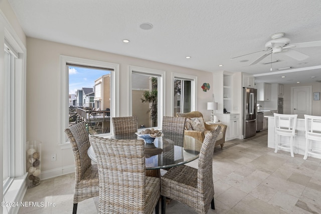 dining area featuring a textured ceiling and ceiling fan