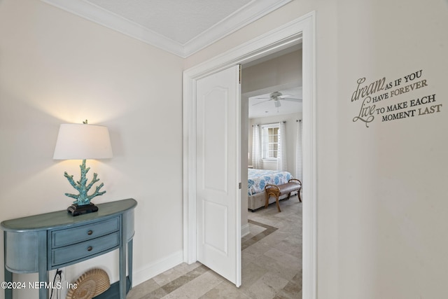 hall with crown molding and baseboards