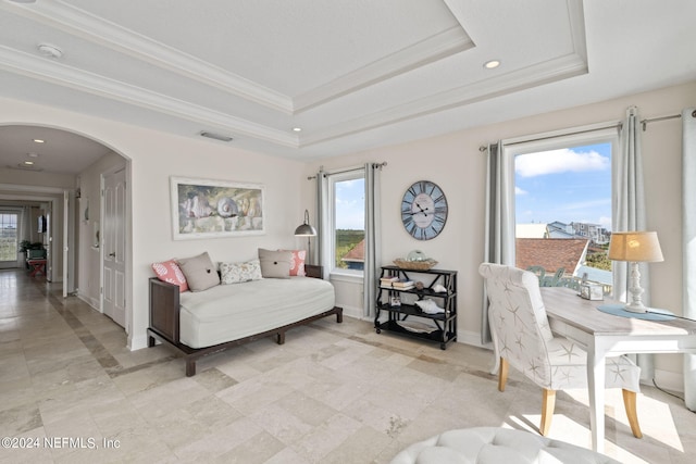 interior space featuring baseboards, visible vents, a tray ceiling, arched walkways, and ornamental molding