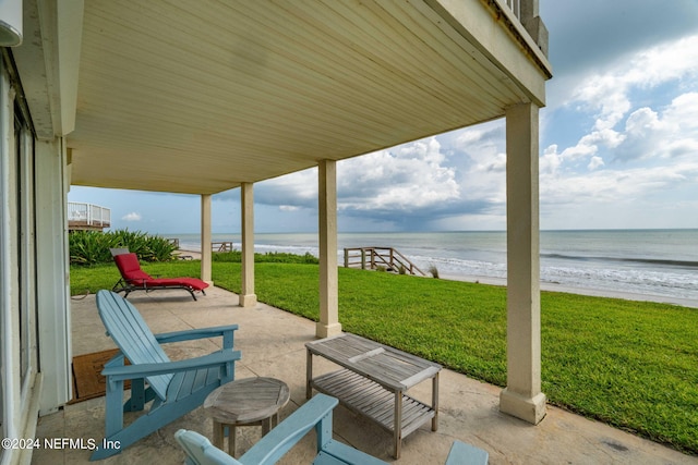 view of patio / terrace featuring a water view and a view of the beach