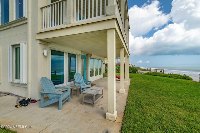 view of patio with a balcony and a water view