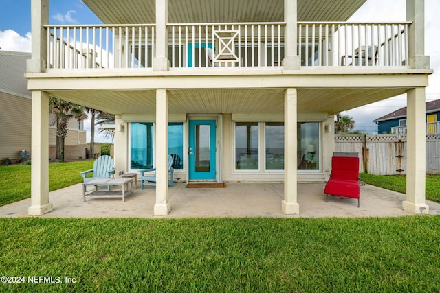 rear view of house with a yard, a patio area, and fence