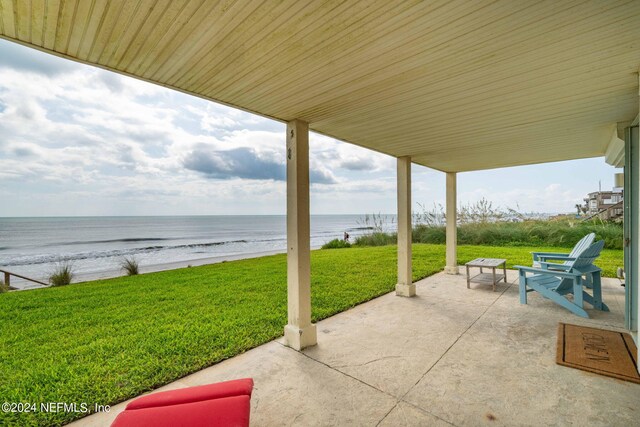 view of patio featuring a view of the beach and a water view